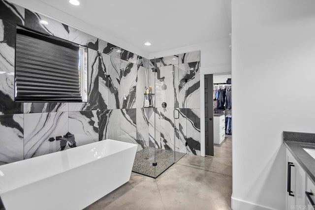 bathroom with plus walk in shower, vanity, and concrete floors