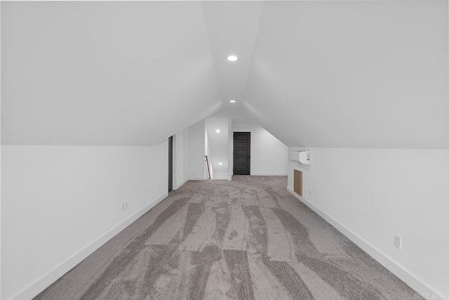 additional living space with lofted ceiling and light carpet