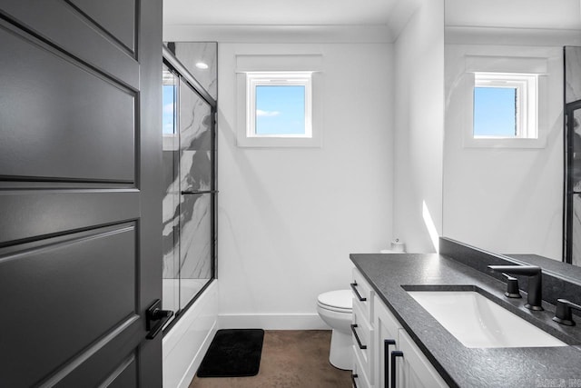 full bathroom with toilet, plenty of natural light, shower / bath combination with glass door, and vanity