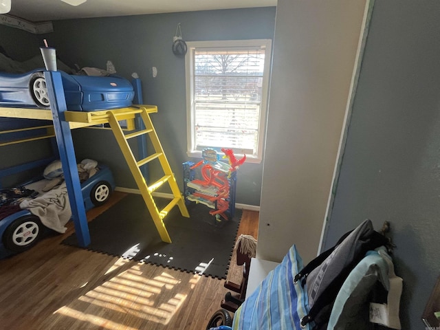 bedroom with dark wood-type flooring