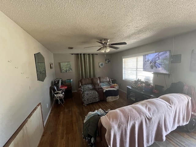 living room with dark wood-type flooring, ceiling fan, and a textured ceiling