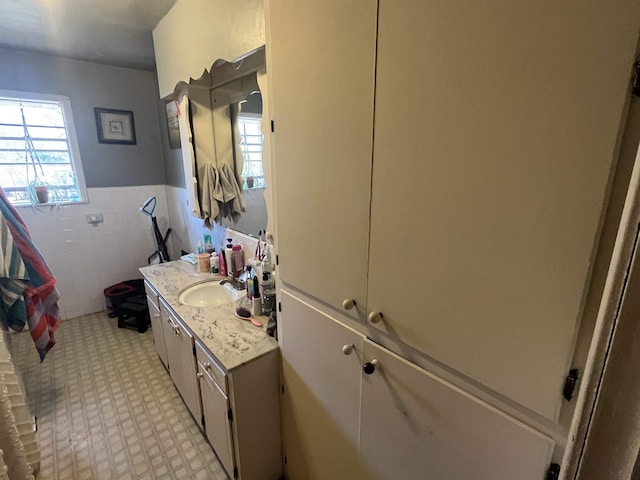 bathroom with tile walls and vanity