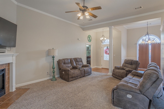 carpeted living room with ornamental molding, ceiling fan, and a fireplace