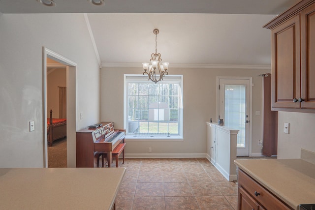 tiled dining space with an inviting chandelier and ornamental molding