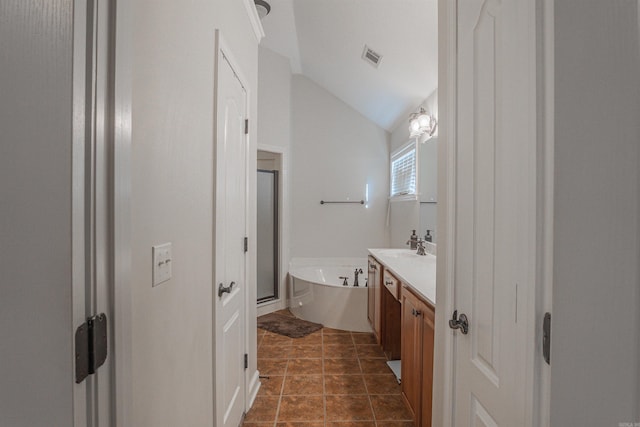 bathroom featuring shower with separate bathtub, lofted ceiling, vanity, and tile patterned floors