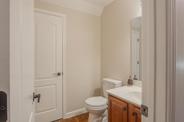 bathroom with tile patterned flooring, vanity, and toilet