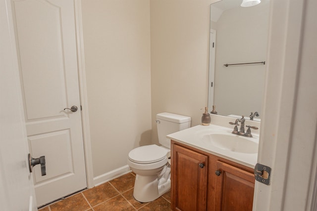 bathroom with vanity, tile patterned floors, and toilet