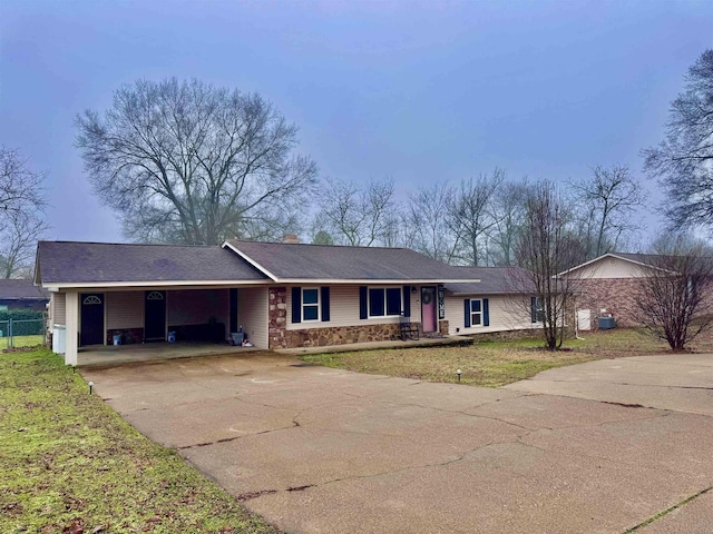 ranch-style home with a front lawn and a carport