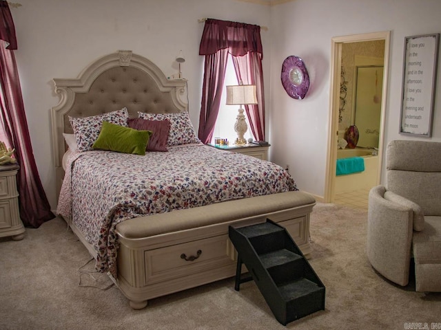 carpeted bedroom featuring ensuite bath