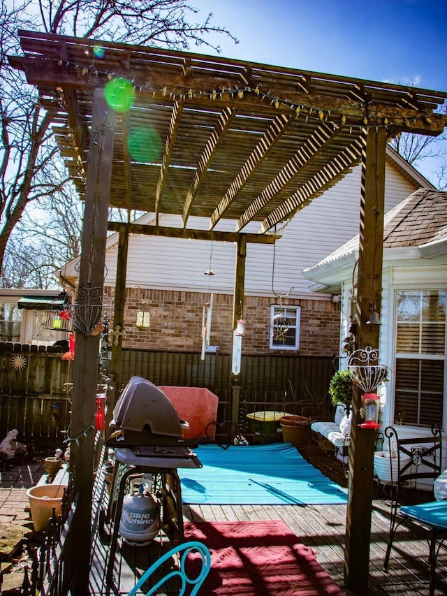 view of patio with a wooden deck, area for grilling, and a pergola