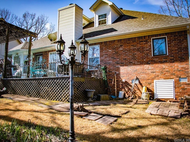 rear view of property with a yard, a patio area, and a deck