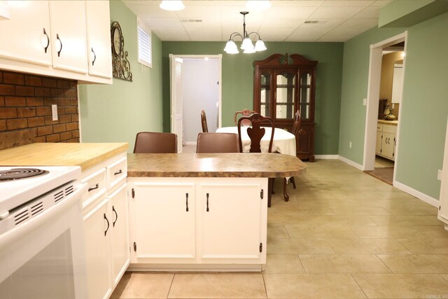 kitchen featuring decorative light fixtures, white cabinetry, a chandelier, light tile patterned floors, and white electric range oven