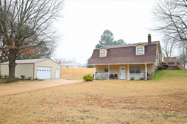 view of front of property with an outbuilding, a garage, covered porch, and a front yard