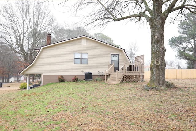 back of house featuring central AC, a yard, and a deck