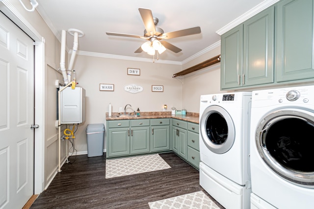 clothes washing area featuring dark hardwood / wood-style flooring, independent washer and dryer, ornamental molding, and cabinets