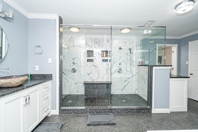 bathroom with vanity, a shower with door, and ornamental molding