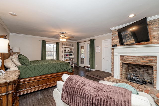 bedroom with crown molding, wood-type flooring, and a fireplace