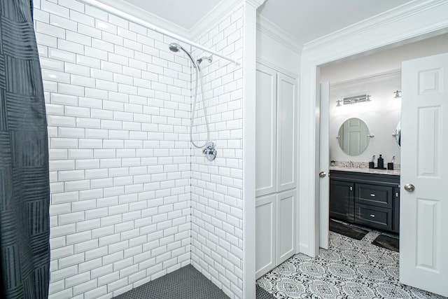 bathroom featuring vanity, ornamental molding, and a tile shower