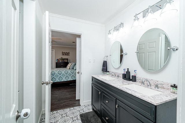 bathroom with ornamental molding, hardwood / wood-style floors, and vanity