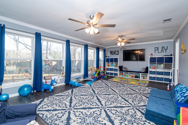 recreation room with hardwood / wood-style flooring and ornamental molding