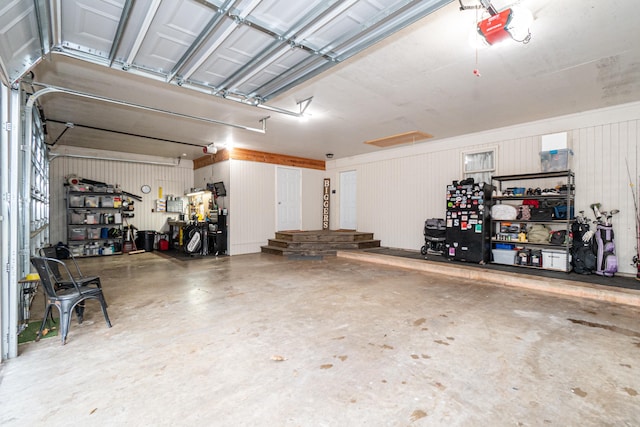 garage featuring a garage door opener and a workshop area