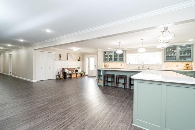 kitchen featuring a healthy amount of sunlight, decorative light fixtures, a center island, and decorative backsplash