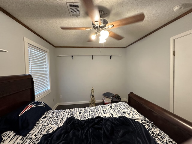 bedroom with crown molding, a textured ceiling, and ceiling fan