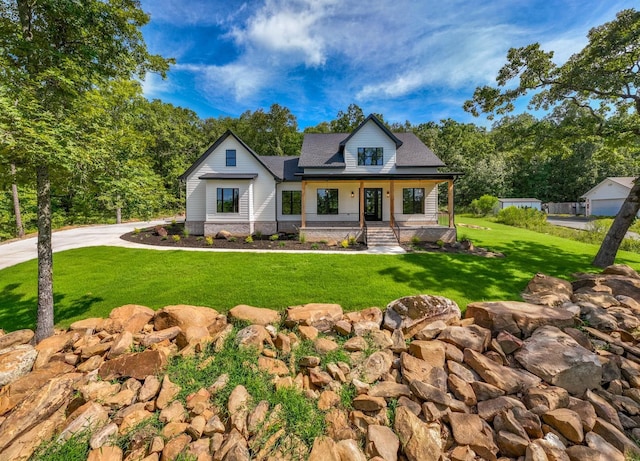 view of front of house with a porch and a front lawn