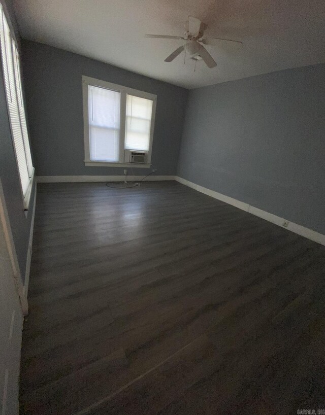 unfurnished room featuring dark hardwood / wood-style flooring and ceiling fan