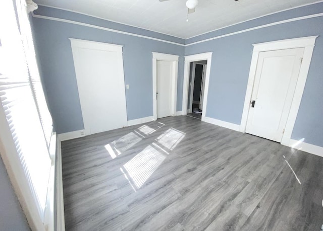 unfurnished bedroom featuring hardwood / wood-style flooring and ceiling fan