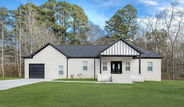 view of front of house featuring a garage and a front lawn