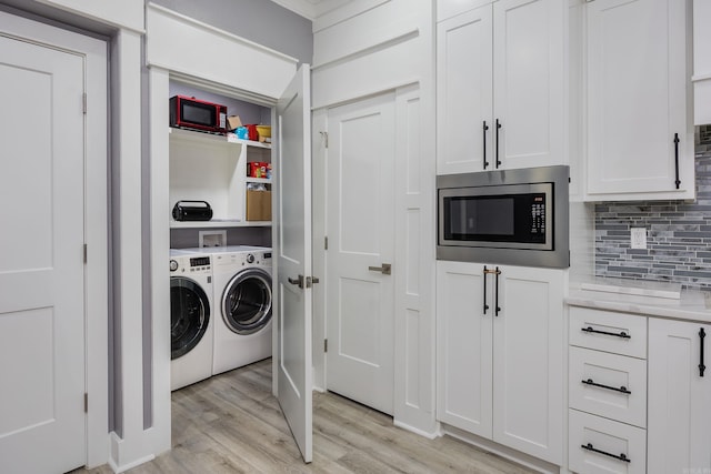 washroom featuring separate washer and dryer and light wood-type flooring