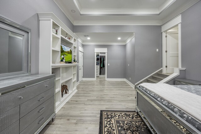 interior space with light hardwood / wood-style floors and a tray ceiling