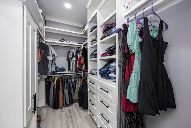 walk in closet featuring light hardwood / wood-style flooring