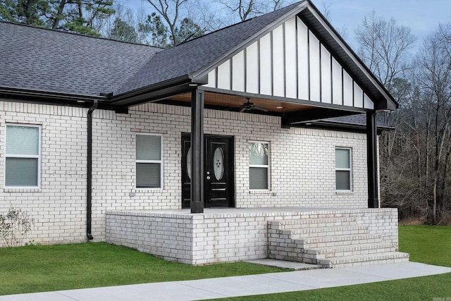 view of side of home featuring ceiling fan and a lawn