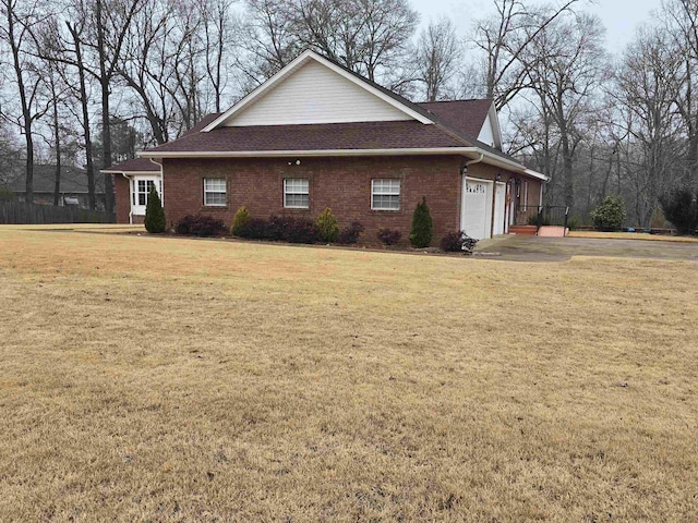 view of home's exterior featuring a garage and a lawn