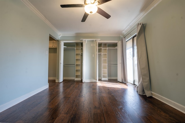 unfurnished bedroom featuring two closets, ornamental molding, dark hardwood / wood-style floors, and ceiling fan