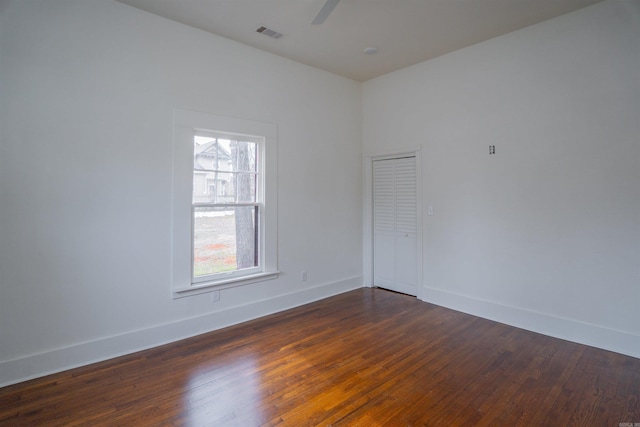 unfurnished room featuring dark hardwood / wood-style floors and ceiling fan