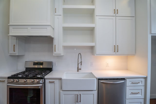 kitchen featuring tasteful backsplash, sink, white cabinets, and appliances with stainless steel finishes