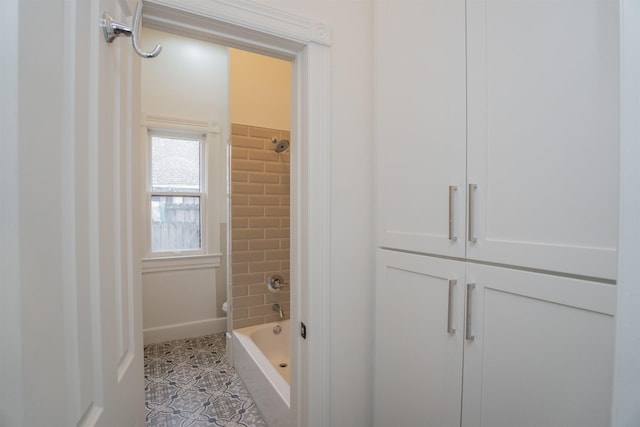 bathroom featuring tile patterned floors and tiled shower / bath combo