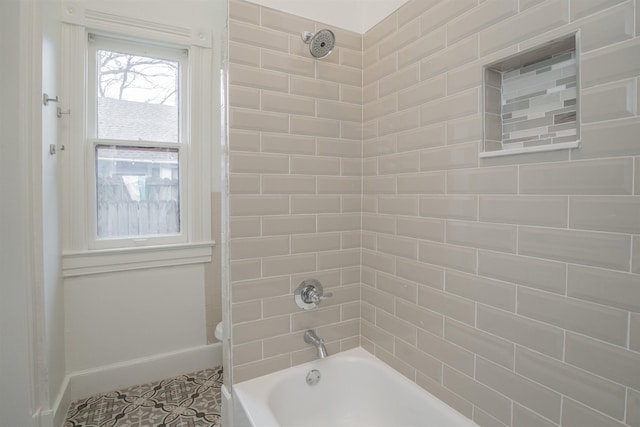 bathroom featuring toilet and tiled shower / bath combo