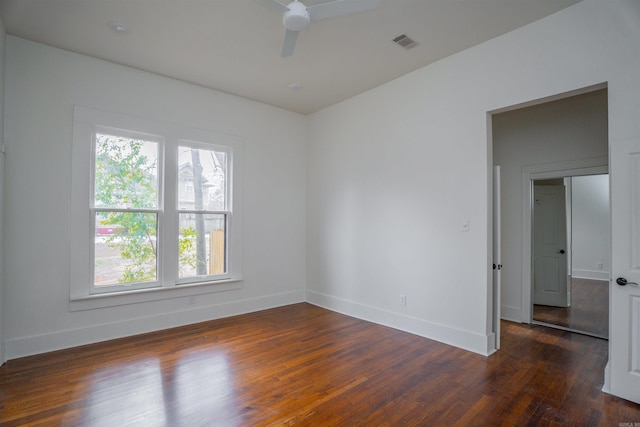 empty room featuring ceiling fan and dark hardwood / wood-style flooring