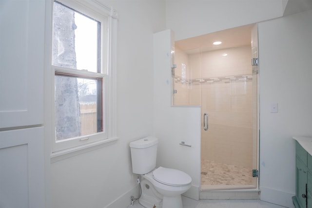 bathroom with vanity, toilet, and a shower with door