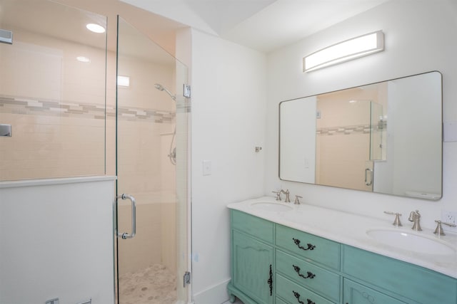 bathroom with vanity and a shower with shower door