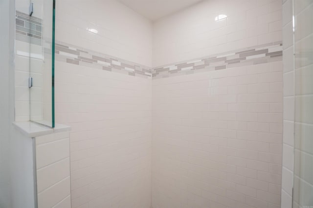 bathroom with tiled shower