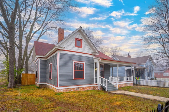 view of front of house with a front yard and a porch