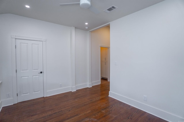 spare room with dark wood-type flooring and ceiling fan