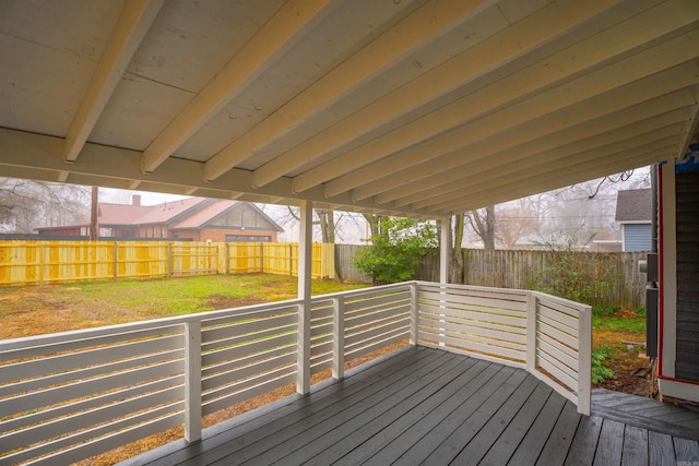 wooden terrace with a lawn