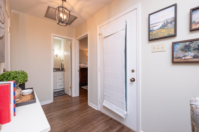 foyer with dark hardwood / wood-style flooring and a notable chandelier