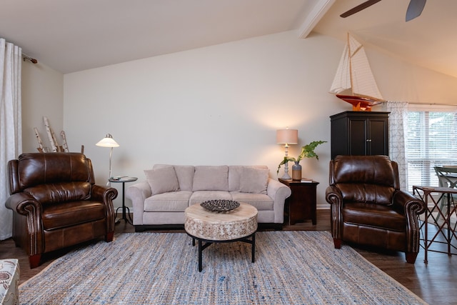 living room featuring dark wood-type flooring and vaulted ceiling with beams